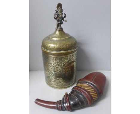 A chase engraved brass Indian lidded caddy with Ganesha top detail, 33cm and a leather powder case with straw detail 