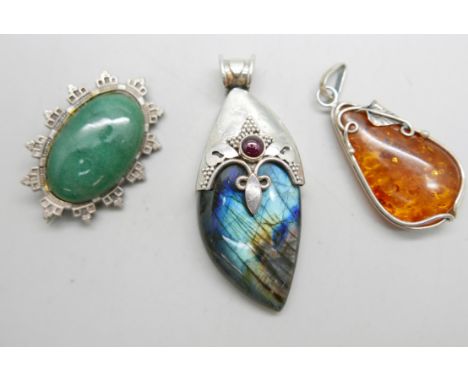 A Victorian silver and jade brooch, Birmingham 1884, a silver and amber pendant and a silver and quartz pendant 