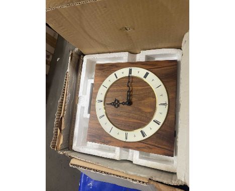 Modern wall clock with cream dial with black Roman numerals on faux wood effect backing, boxed