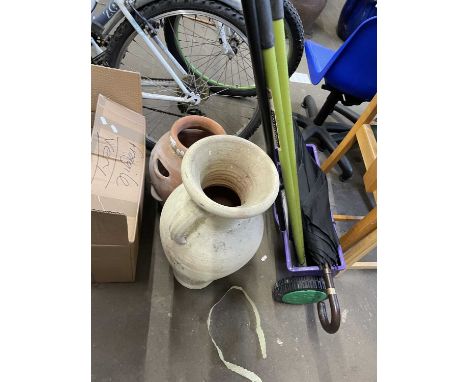 Terracotta strawberry planter together with a wheeled lawn feeder and other gardening implements