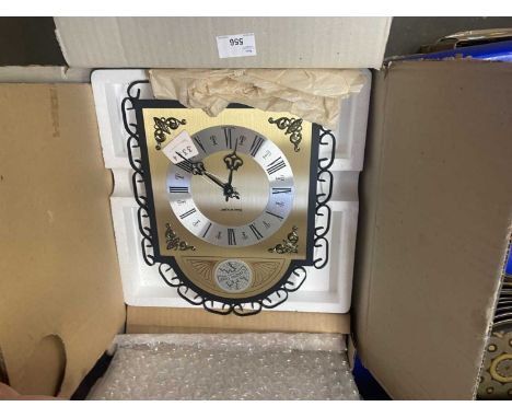 A Kieninger wall clock with brushed brass and chrome effect dials, Roman numerals, black hands and black metal work surround,