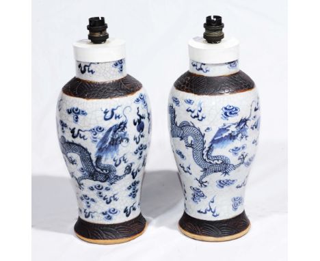 A PAIR OF CHINESE CRACKLE WARE BLUE AND WHITE TABLE LAMPS with shades, 33cm high (2)