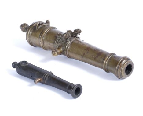 A SOUTH INDIAN BRONZE MODEL CANNON cast with twin lions, 23cm and another miniature bronze cannon, 13cm long (2)