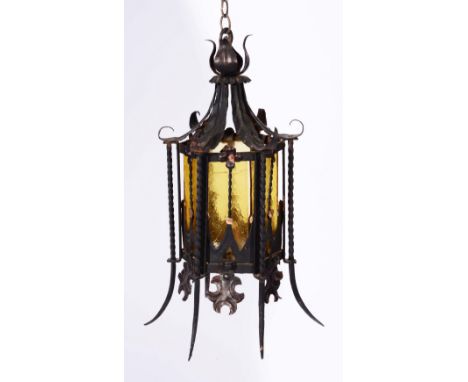 AN OLD WROUGHT IRON HANGING LANTERN with glass panels and ceiling boss, 40cm high