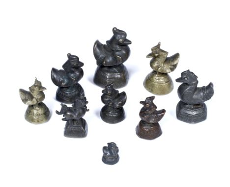A GROUP OF NINE ASHANTI BRONZE GOLD WEIGHTS of duck and dragon form, 7cm to 2cm high (9)