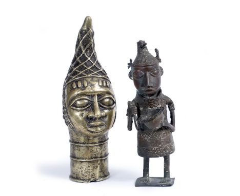 A BENIN BRONZE HEAD of an Oba or traditional ruler with lattice head dress, 31cm high; and Benin bronze figure of an attendan