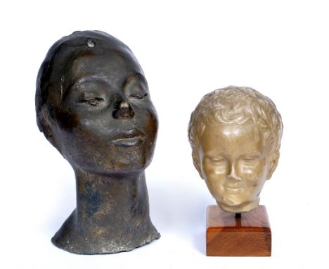 A CAST BRONZE HEAD of an African girl, indistinctly signed to the base, 32cm high, and a plaster head after the Antique on a 