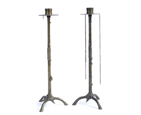 A PAIR OF 19TH CENTURY FRENCH BRONZE CANDLESTICKS after a design by Auguste Maximilian Delafontain circa 1880 each on a trifo