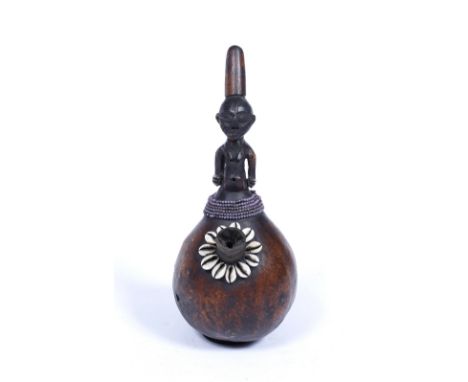 A SOUTH AFRICAN GOURD PIPE with carved figure finial and shell and beaded ornament, 30cm high - Purchased in Cape Town