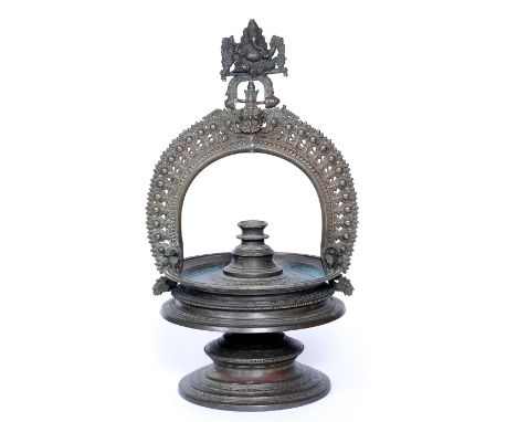 A 17TH CENTURY INDIAN BRONZE HANGING LAMP, the hanger in the form of Ganesha with demon below, probably Kerala, 45cm high x 2