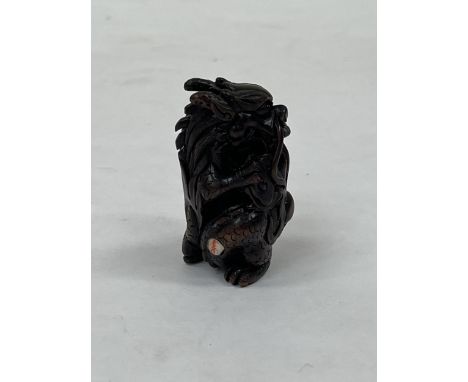 A Japanese carved boxwood dragon netsuke 2¼" high.