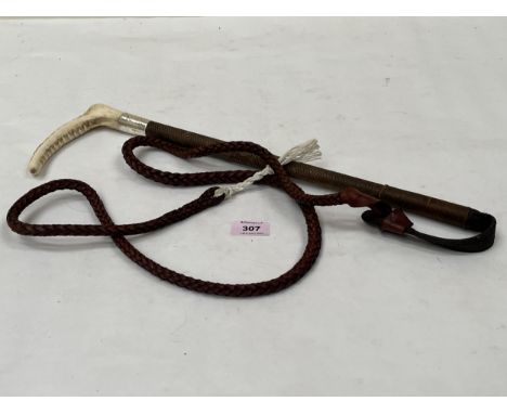 A riding whip with silver collar.
