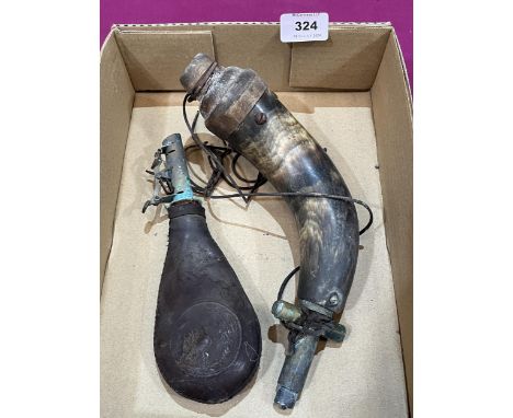 A powder horn and a leather shot flask.