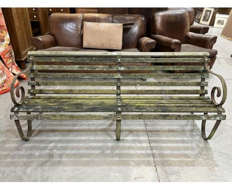 An iron and wood slatted garden bench. 72" wide.