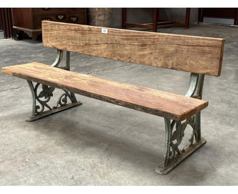 A cast iron and oak low bench with leafy scrolled ends. 44" wide.