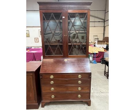 A 19th Century mahogany astragal glazed bureau bookcase with fitted interior on bracket feet. 44"w x 91"h.