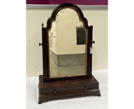 A George III mahogany dressing table mirror, the old plate in parcel gilt arched frame, the base with cavetto drawer raised o