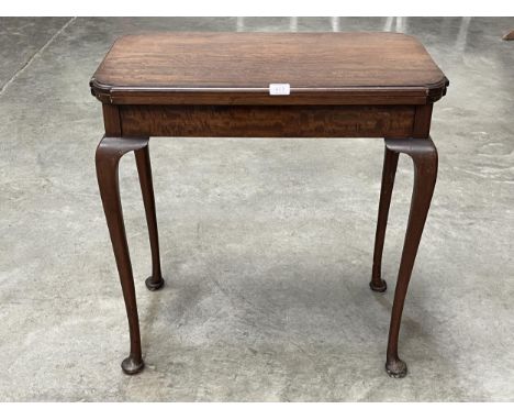 An early 20th Century mahogany card table on turned tapered legs with pad feet. 28" wide