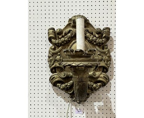 A 19th Century carved giltwood wall sconce, later converted to electric light. 17" high.