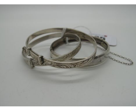 A Child's Bangle, with part engraved detail, to snap clasp, and safety chain, stamped "Sterling", together with two children'