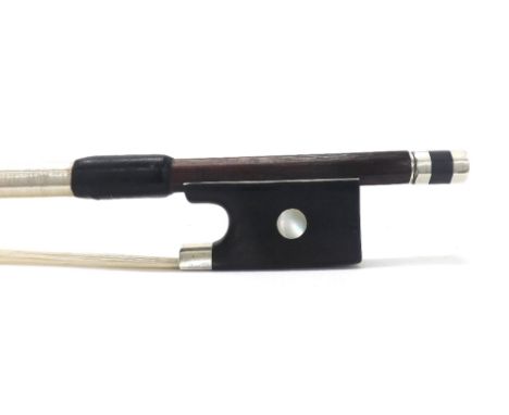 Silver mounted violin bow, unstamped, the stick octagonal, the ebony frog inlaid with pearl eyes and the ebony adjuster with 