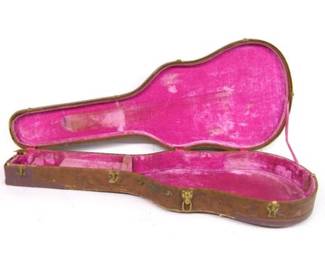 Gibson hollow body electric guitar hard case, circa 1959, with brown exterior and pink interior, in tired condition with tape