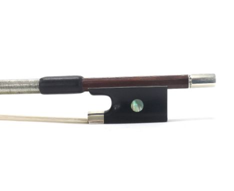 Good French silver mounted violin bow, unstamped, the stick round, the ebony frog inlaid with pearl eyes and with a silver ov