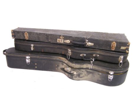 1970s acoustic guitar case in need of repair, with black exterior and yellow interior; together with two vintage electric gui