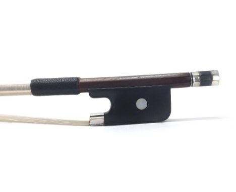 French silver mounted violin bow, indistinctly stamped, the stick round, the ebony frog inlaid with pearl eyes and the ebony 