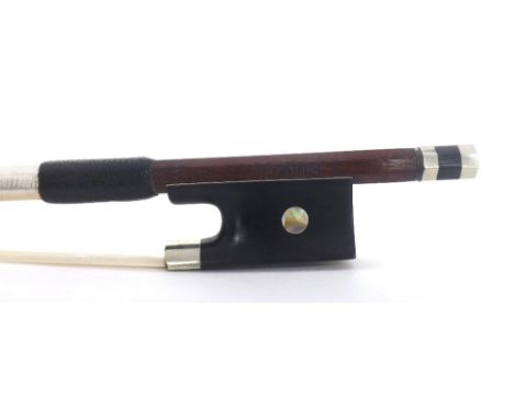 Silver mounted violin bow stamped Simon, the stick round, the ebony frog inlaid with pearl eyes and the ebony adjuster with t