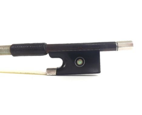 French silver mounted violin bow by and stamped Vtor Fetique á Paris, the stick round, the ebony frog inlaid with silver ring