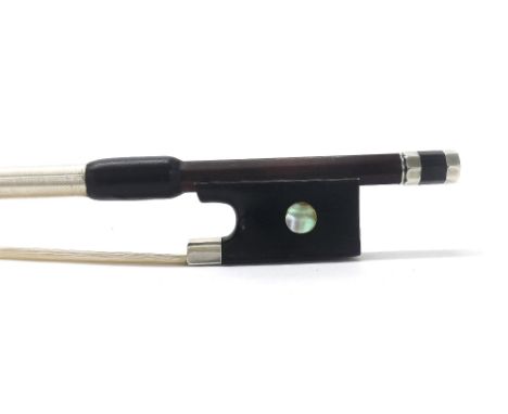 Silver mounted violin bow, unstamped, the stick round, the ebony frog inlaid with large pearl eyes and the ebony adjuster wit