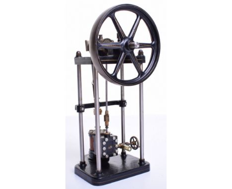 A small finely engineered model of a single cylinder vertical steam engine, with base mounted wooden lagged cylinder, valve c