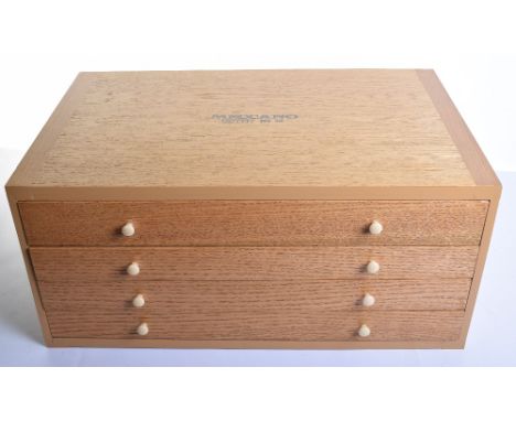 Meccano Outfit No.10, 1970s four drawer wooden case containing a wide selection of yellow, blue, black and plain parts, wheel
