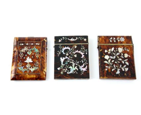19th Century tortoiseshell card case inlaid in mother of pearl with a man in uniform on horseback and castle to verso, two ot