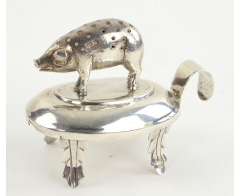 Pig pin cushion in unmarked white metal, testing as silver  mounted on an oval base on leaf capped legs 10cm long and 8cm hig