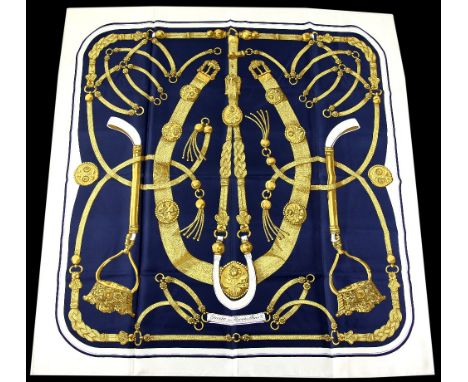 Hermes “Gaucho” silk scarf in navy and gold with white border designed by Caty Latham in 1978.(89 x 90 cm).    Very good. Sil