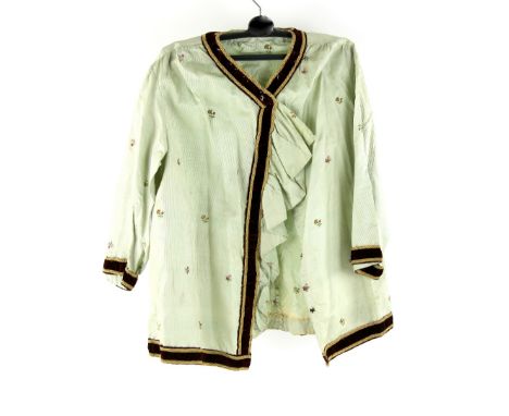 A pale green silk blouse hand embroidered with floral sprigs and later velvet braiding, fabric 18th century with later adapta