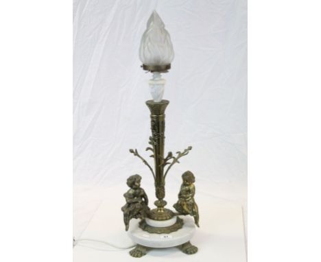 Large Torchere style table light with Gilt metal Cherub figures and central column, Brass Lion paw feet, circular Marble base