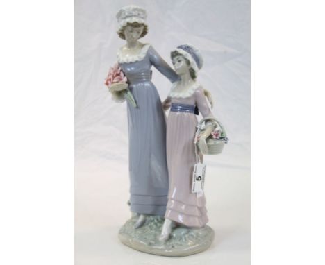 Large Lladro ceramic figurine of "Daughters", both carrying flowers and standing approx 32.5cm