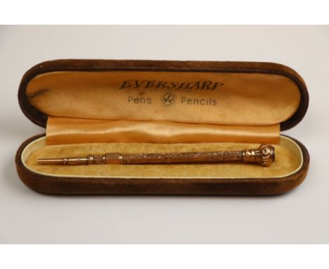 Rose metal propelling pencil with carnelian finial and bright cut foliate decoration, length when extended approximately 10cm