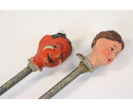 Two Papier mache painted Puppet heads on sticks, a female and a Devil, both approx 52cm long including sticks