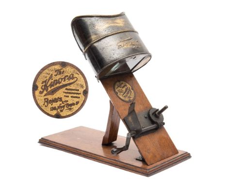 Kinora Viewer: with gilt lacquered viewer and manual hand crank drive on an oak plinth base, maker's plate to frame' The Kino