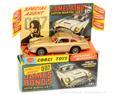 Corgi 261 "James Bond" - Aston Martin DB5 taken from the film "Goldfinger" - gold body, red interior with "James Bond &amp; B