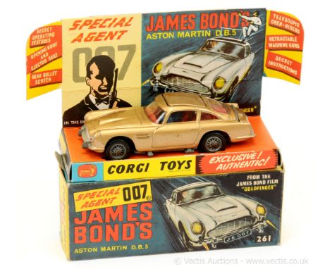 Corgi 261 "James Bond" Aston Martin DB5 taken from the film "Goldfinger" - gold body, red interior with "James Bond and Bandi