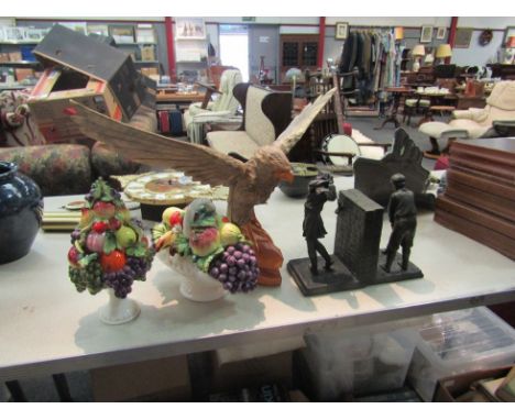 A pair of resin golfing bookends, wooden eagle and two ceramic fruit baskets 