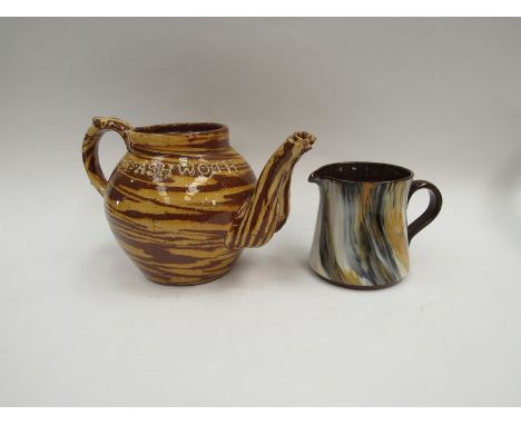 An Edwardian slipware double spout teapot "Mrs Ashworth 1907" and slipware jug    