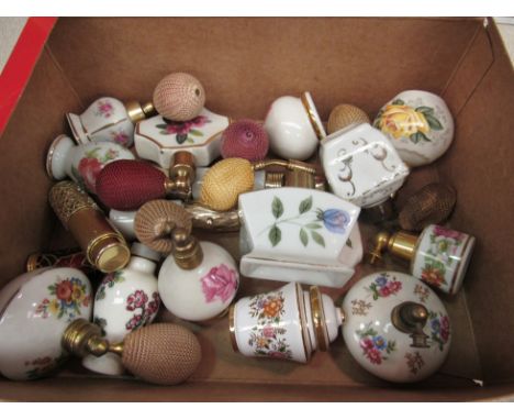 A box containing a selection of mostly ceramic floral design perfume bottles 