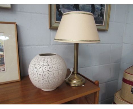 A cream pierced bulbous table lamp together with another cream shaded table lamp