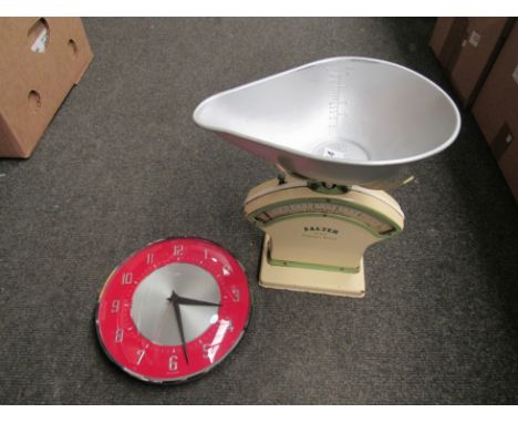 A red Metamec wall clock together with a set of Salter scales 